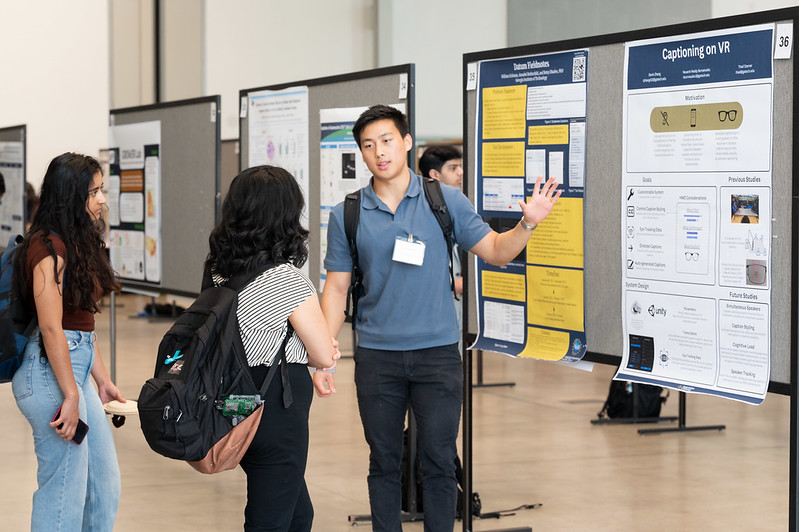 Student presenting a poster at the Spring Symposium