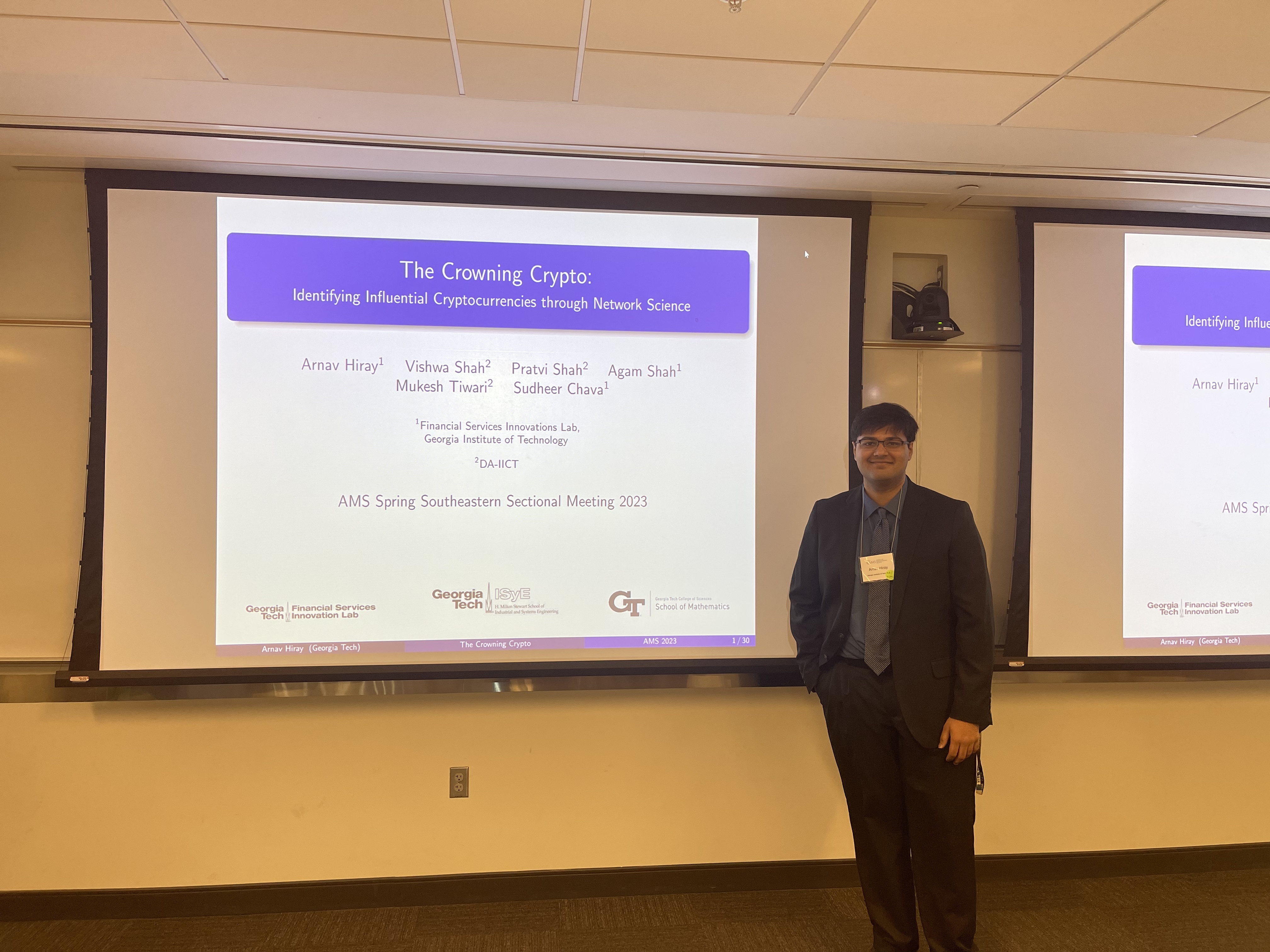 Arnav stands in front of presentation slides.