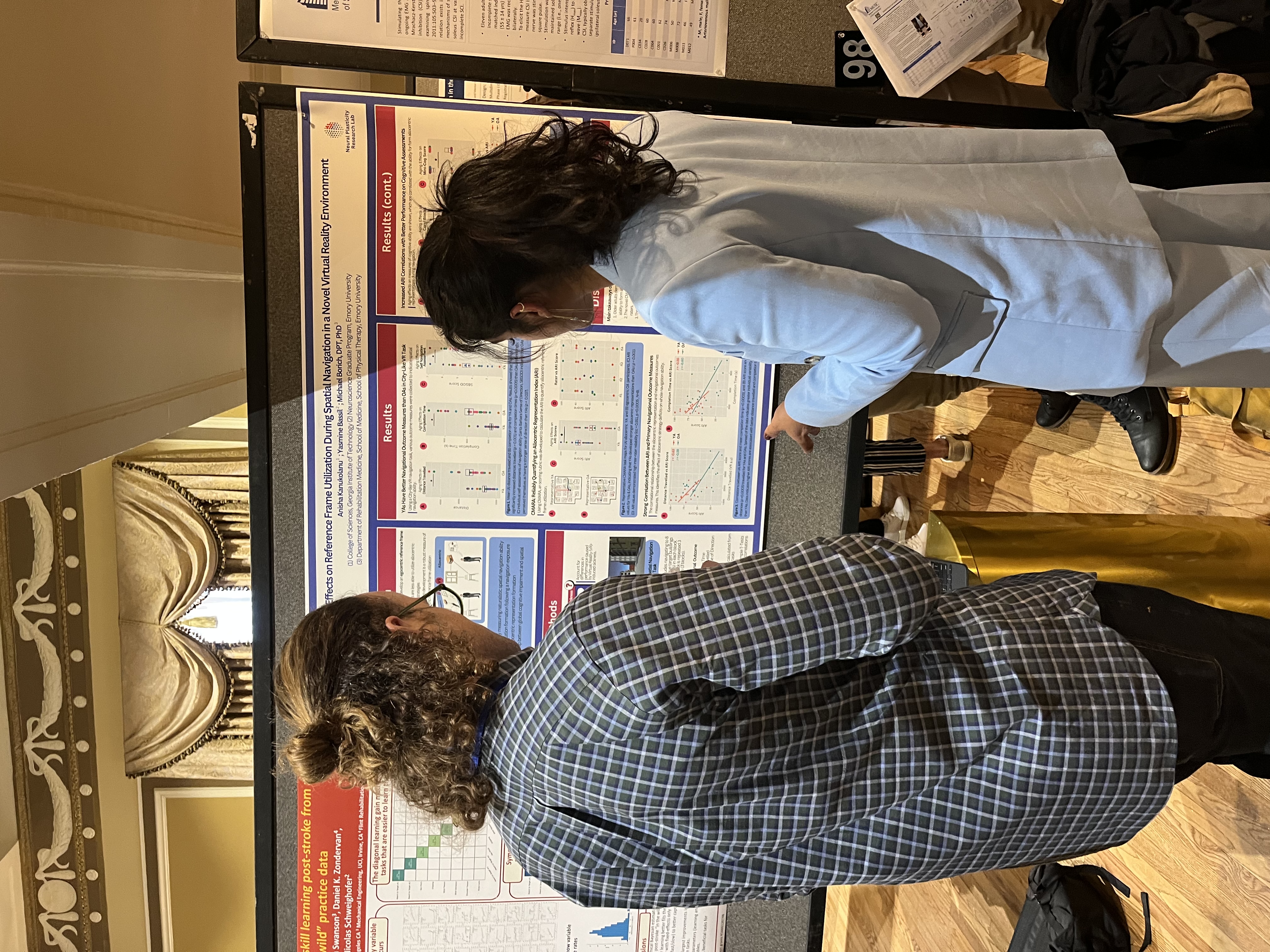 Anisha discussing her work with a colleague during a poster session.