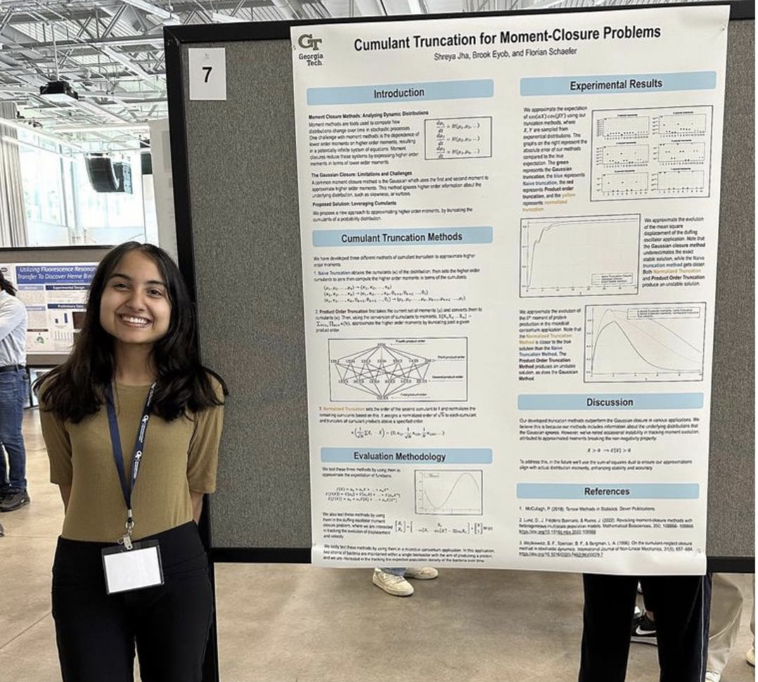 Shreya stands next to a research poster.