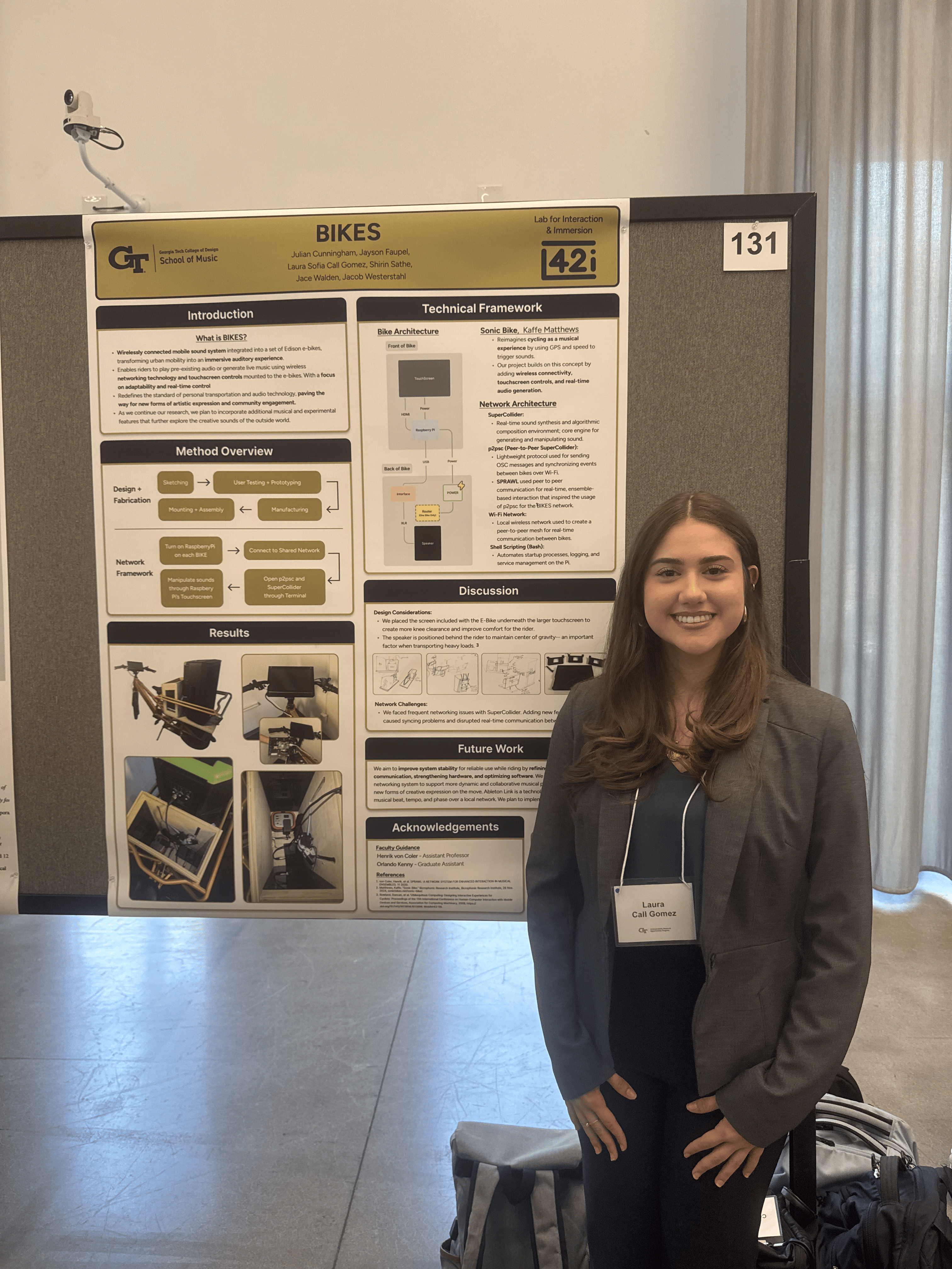 Sara stands by a poster about her research.