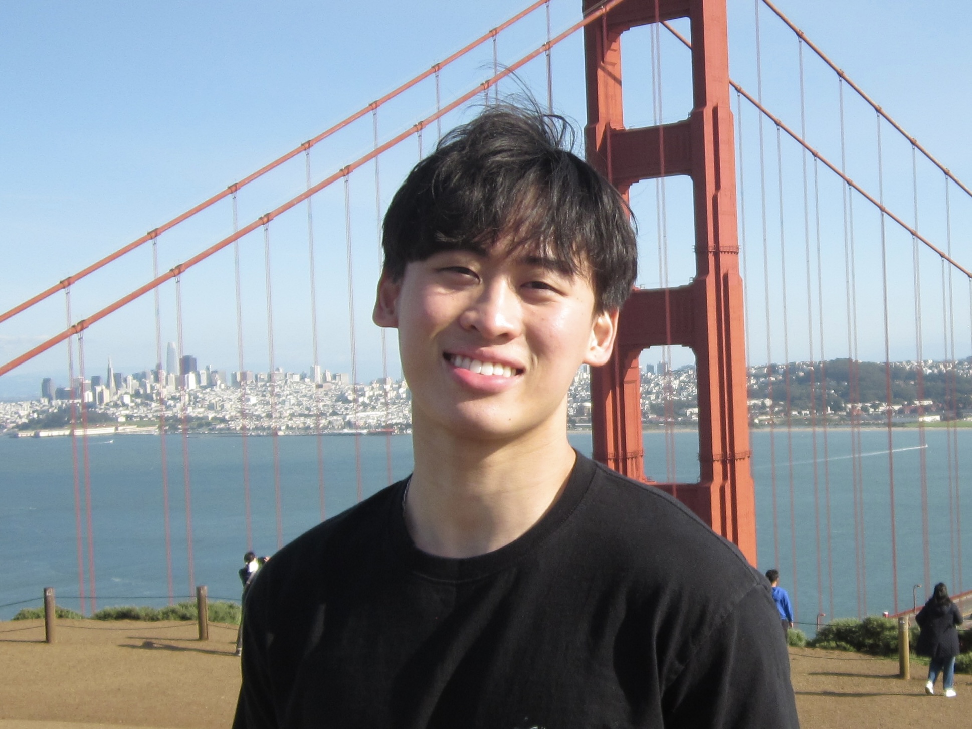 Edison smiles at the camera, with the Golden Gate Bridge in the background.